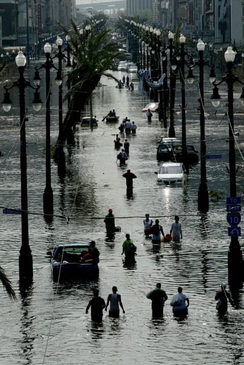 Stranded people make their way along Canal Street in New Orleans on 30 Aug 2005 as Hurricane Katrina struck