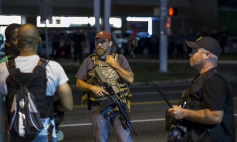 Members of the oath keepers walk with their personal weapons on the street during protests in Ferguson.