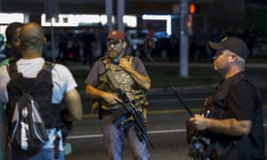 Members of the Oath Keepers walk with their personal weapons on the street during protests in Ferguson, Missouri .