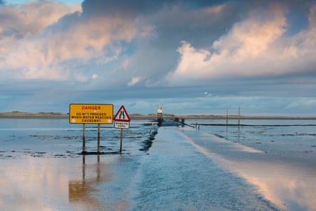 Holy Island, also known as Lindisfarne, in the distance with the causeway in the foreground