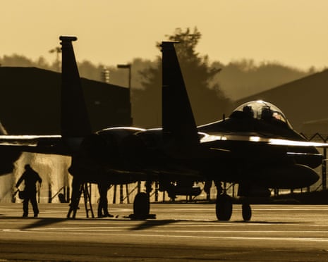 A US F-15 fighter on the tarmac at sunset