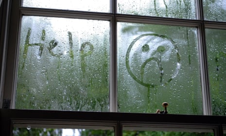 Sad face drawn in window condensation