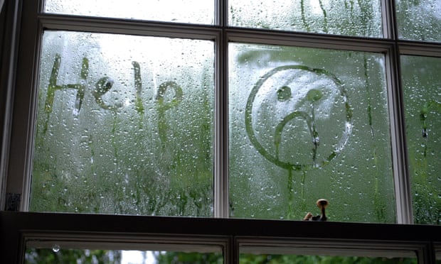 Sad face drawn in window condensation.