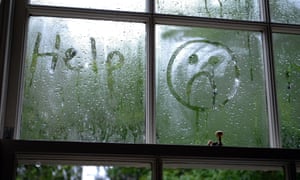 Sad face drawn in window condensation
