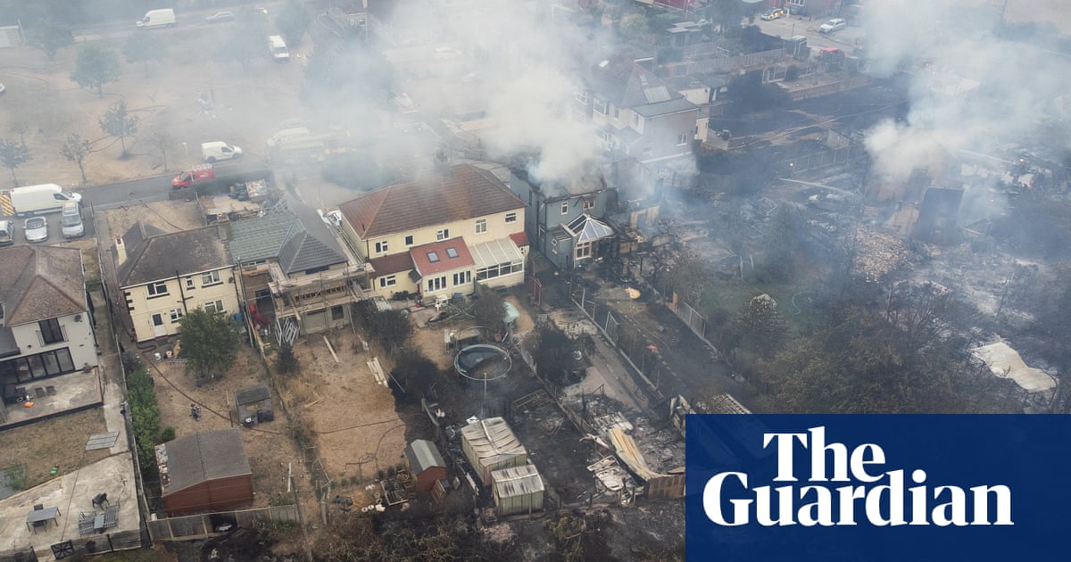‘Absolute hell’: firefighters battle blazes across UK on record hottest day