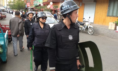 Police patrol a Uighur neighbourhood in Urumqi, the capital of Xinjiang. 