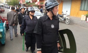 Police patrol a Uighur neighbourhood in ÃÂrümqi, China