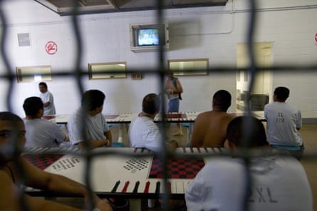 Foreign nationals watch television at a federal detention centre