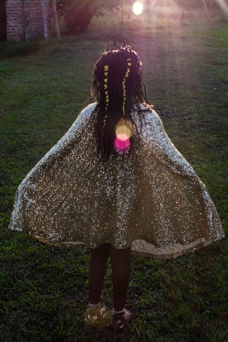 A girl dressed as the Star of Bethlehem watches the sunset in Quinamayó.