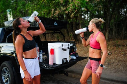 women drink from bottles