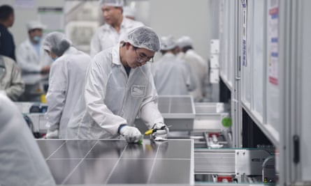 A worker produces solar photovoltaic modules used for solar panels at a factory in China’s eastern Jiangsu province in May 2023.