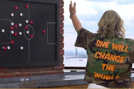 Emma Hayes shows the back of he jacket which says “She will change the world”