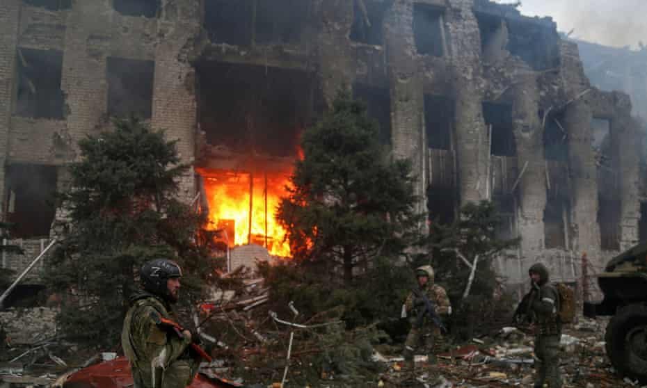 Pro-Russian troops gather outside the destroyed Azovstal iron and steelworks administration building in Mariupol, Ukraine.