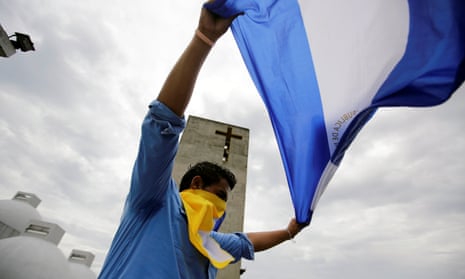 A man holds a national flag after a mass at the Metropolitan Cathedral in Managua, Nicaragua, to demand the release of demonstrators detained during protests against the government.