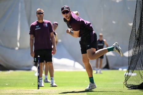 Tom Hartley of England bowls watched by coach Andrew Flintoff during an England Lions training session