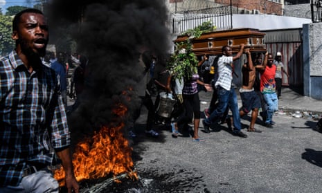 A coffin is borne in Port-au-Prince, Haiti, where violent anti-government protests were frequent last year