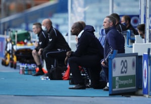 Alex Dyer, Kilmarnock manager, kneels in support of Black Lives Matter before a match, as play resumes behind closed doors