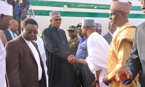 Muhammadu Buhari greets officials at Kaduna airport