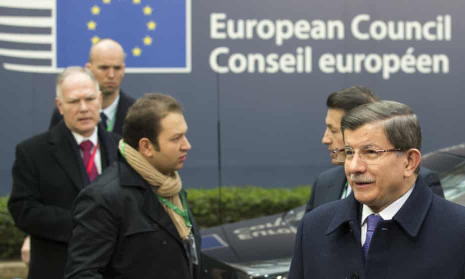 Turkish prime minister Ahmet Davutoğlu, right, arrives for an EU summit in Brussels.