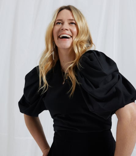 Edith Bowman, in a black top and trousers, laughing