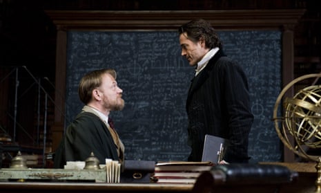 Jared Harris as James Moriarty and Robert Downey Jr as Sherlock Holmes looking at each other in Warner Bros’ 2011 Sherlock Holmes: A Game of Shadows.