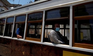 People wearing protective face masks are seen inside a tram at Alfama neighbourhood in Lisbon, Portugal.