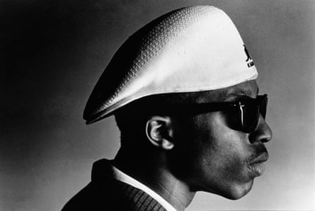 portrait of man in sunglasses and hat looking to side