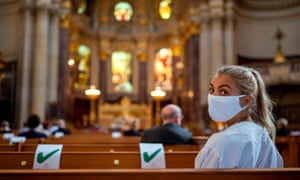 A woman wearing a protective face mask attends a Sunday service at the Berliner Dom cathedral.