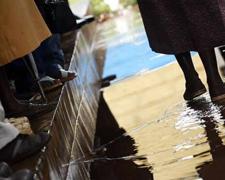 A view from the knees down of patients queuing to see a doctor at a psychiatric centre in one of Nairobi's shantytowns