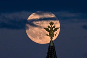 Moscow, Russia. The full moon is pictured behind the two-headed eagle, the national symbol of Russia, atop a building on Red Square