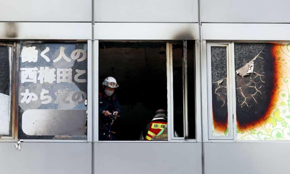 Firefighters work at the scene, where twenty-seven people were feared dead after a blaze at a building in Osaka
