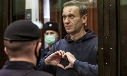 Alexei Navalny makes a heart gesture standing in a cage during a court hearing in Moscow earlier this month