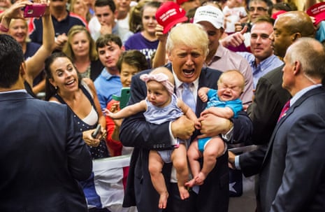 Republican presidential candidate Donald Trump holds baby cousins Evelyn Kate Keane and Kellen Campbell