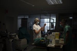 A healthcare worker prepares medication for a Covid-19 patient at one of the intensive care units of the Germans Trias i Pujol hospital in Badalona.