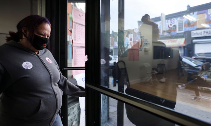 A woman with an “I voted” sticker leaves a polling place in a storefront in the largely Latino Fairhill neighborhood in Philadelphia.
