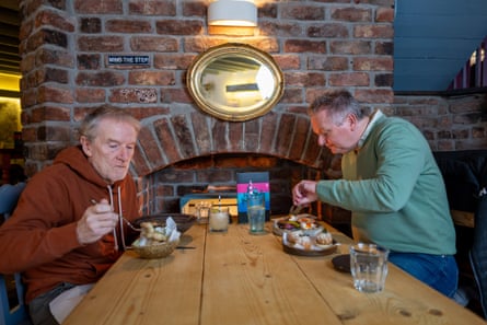 Two men eating at a restaurant table