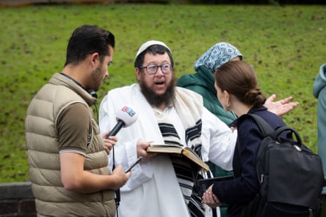 Concerned members of the community near the Heaton Park Hebrew Congregation Synagogue in Manchester