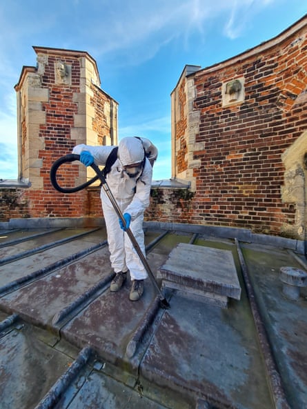 Dr Matthias van Ginneken using a backpack vacuum cleaner to gather material from the roof of Canterbury Cathedral.