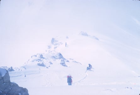 A person walking in a snow-laden field.
