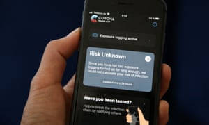 A phone user looks at the English version of the German federal health ministry’s Corona-Warn-App