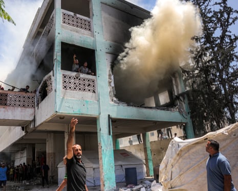 Smoke billows while emergency workers try to put out a fire after an Israeli strike at Unrwa’s Osama bin Zaid school in wester Jabalia, northern Gaza Strip on 27 June.