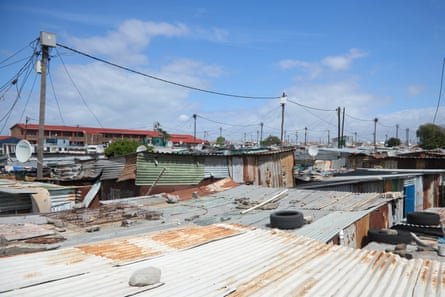 A view across tin roofs, the closest of which is painted white.