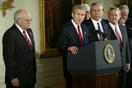 U.S. President George W. Bush speaks before signing the congressional resolution authorizing U.S. use of force against Iraq if needed during a ceremony in the East Room of the White House October 16, 2002. With President Bush is Vice President Dick Cheney (L), Speaker of the House Dennis Hastert (obscured), Secretary of State Colin Powell (3rd R), Secretary of Defense Donald Rumsfeld (2nd R) and Sen. Joe Biden (D-DE).