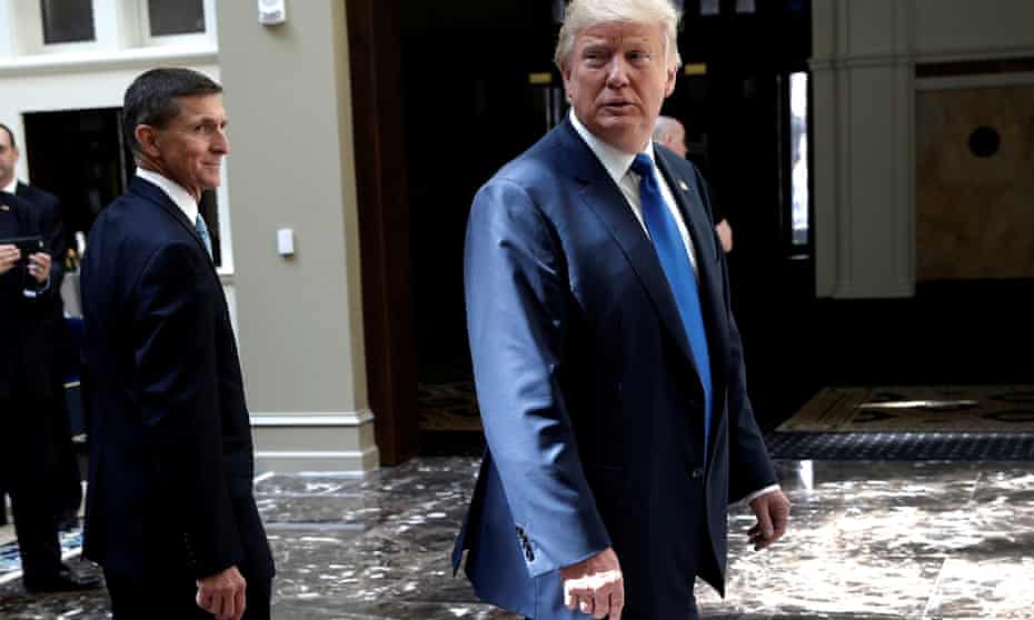 Donald Trump, then a presidential candidate, walks into the atrium of his new hotel on 16 September 2016, with his future national security adviser Michael Flynn.