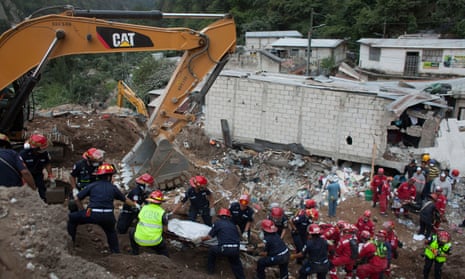 Rescuers move the body of a victim in the El Cambray neighbourhood of Santa Catarina Pinula in Guatemala which has been devastated by a landslide.