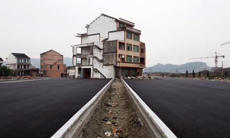 A half-demolished apartment building standing in the middle of a newly-built road thanks to a Chinese couple that refused to move 