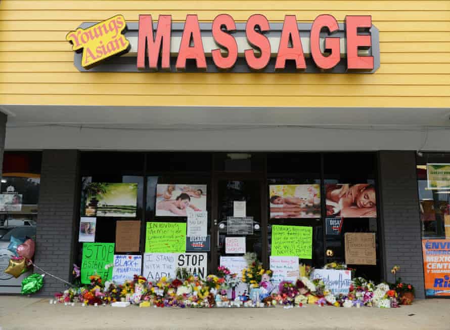 Flowers and candles outside Youngs Asian Massage, where four people were killed in March 2021.