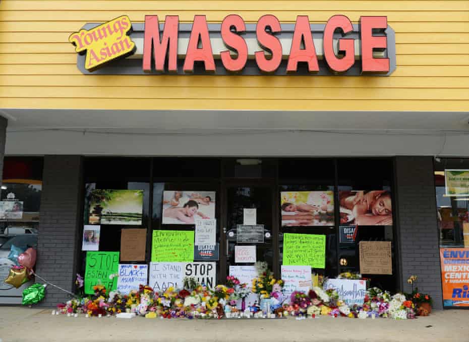 Flowers, candles and signs lie at a makeshift memorial outside Young’s Asian Massage in Acworth, Georgia.