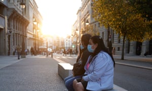 People wearing face masks in Madrid yesterday, when the country’s total Covid cases surpassed 5 million.