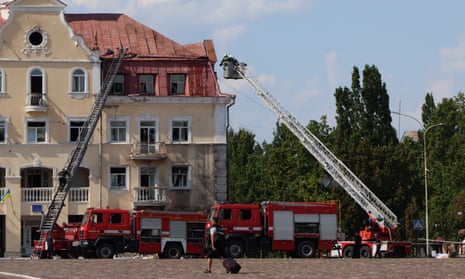Rescuers on a fire truck’s aerial platform extinguish fire ignitions on the Chernihiv courthouse after Russia’s rocket attack on Saturday